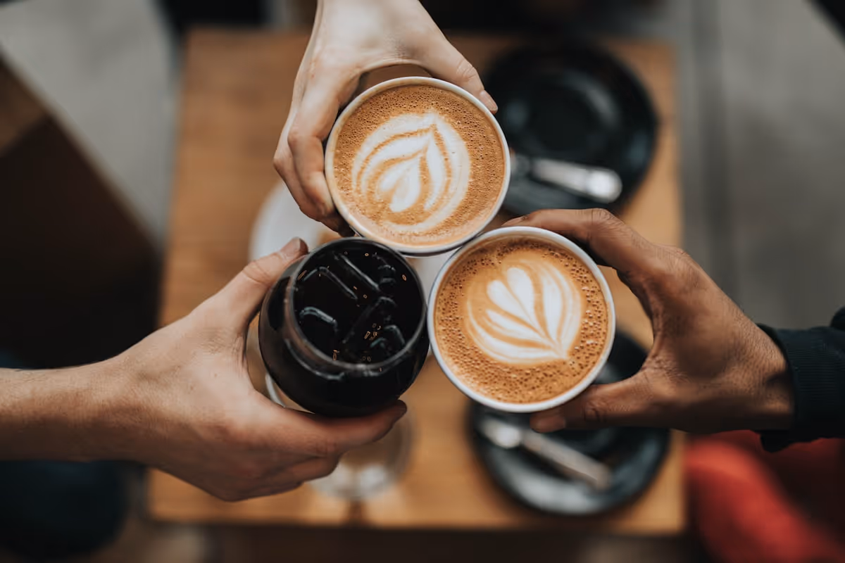 Three people bringing coffee cups together — the original networking protocol